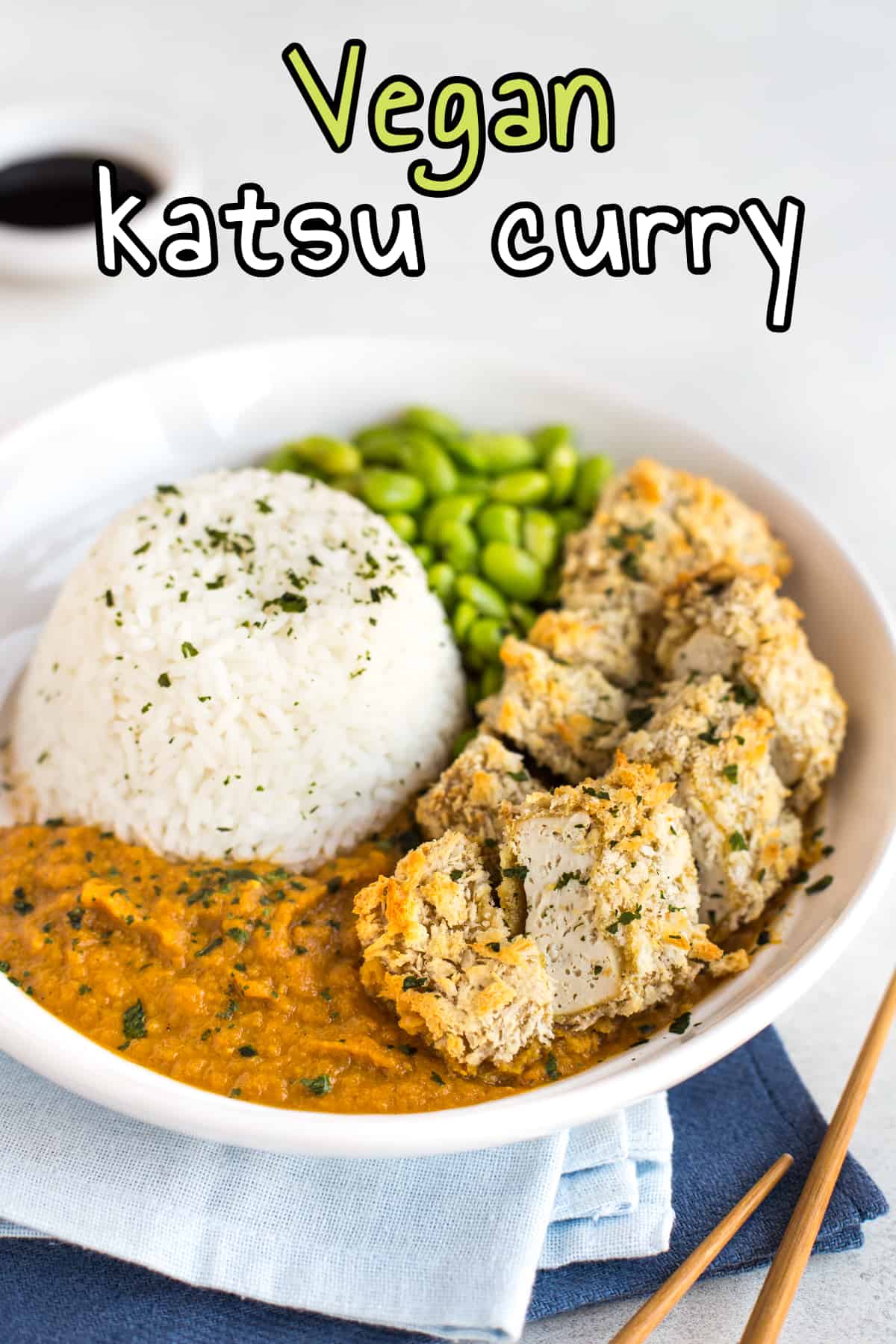 Vegan katsu curry with crispy breaded tofu and rice.