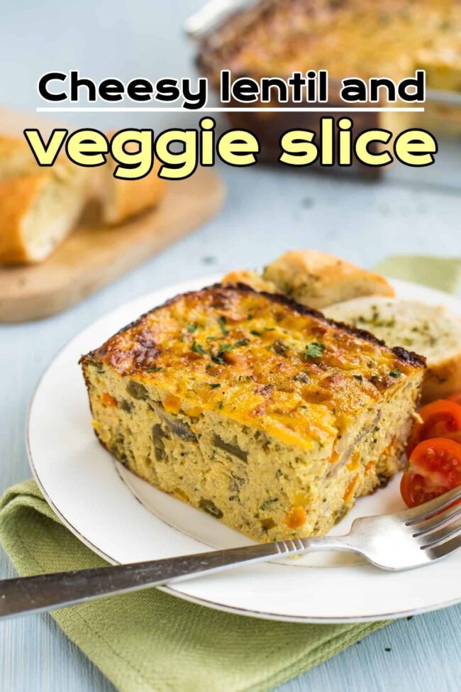 Portion of lentil and veggie slice on a plate with garlic bread
