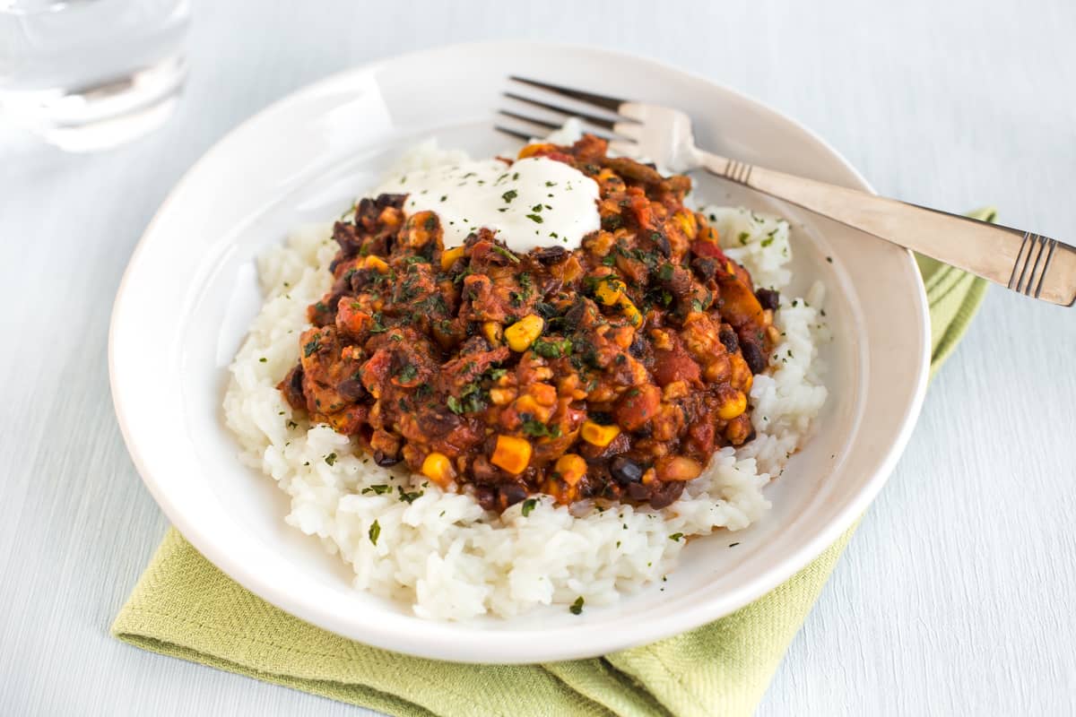 Vegetarian black bean chilli in a bowl with rice.