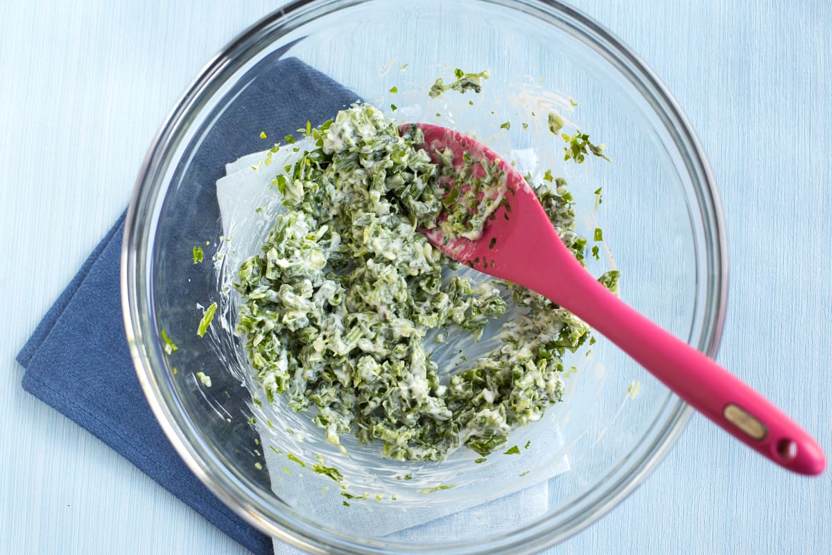 Creamy green bean and mayonnaise mixture in a bowl.