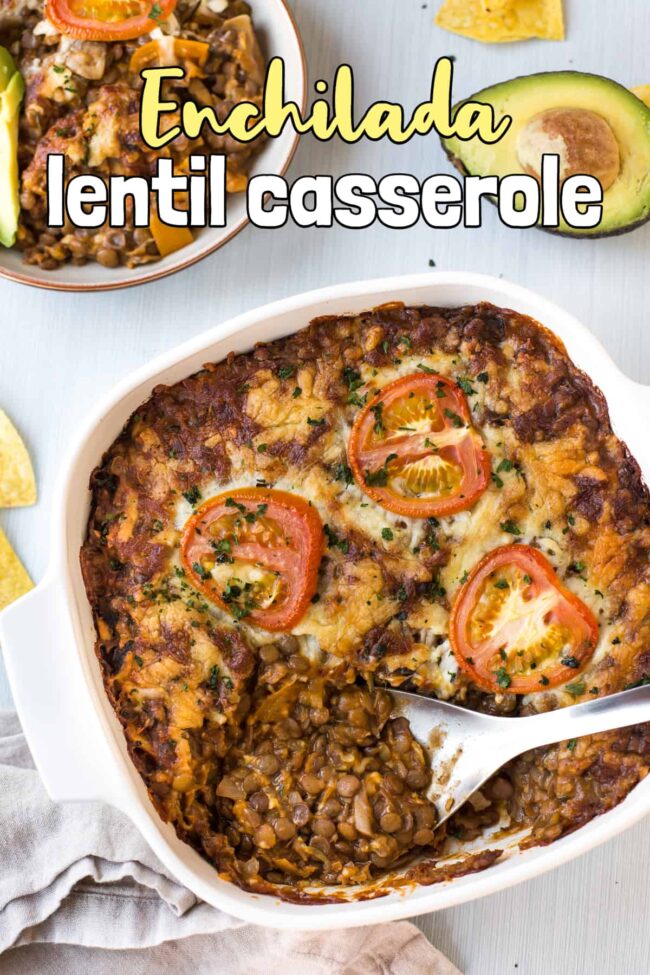 Cheesy lentil casserole in a baking dish with a big spoon taking a scoop.