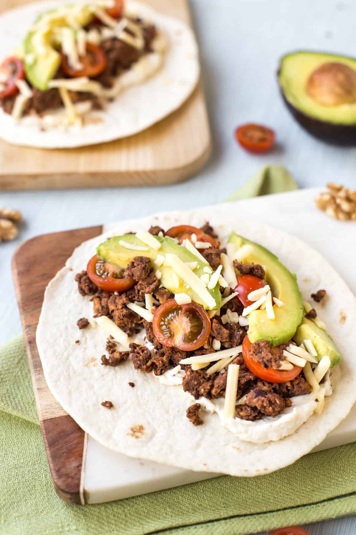 A veggie taco with black bean and walnut taco meat, avocado and tomatoes.