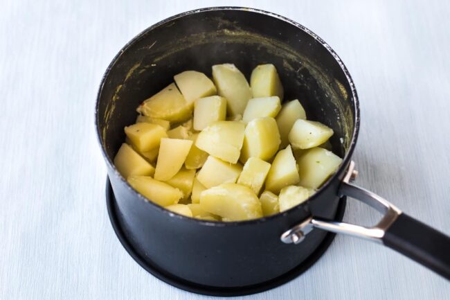 Boiled potatoes in a saucepan.