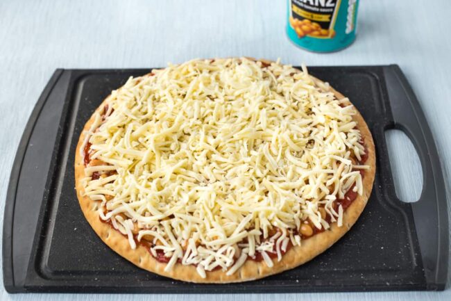 An uncooked cheesy pizza.
