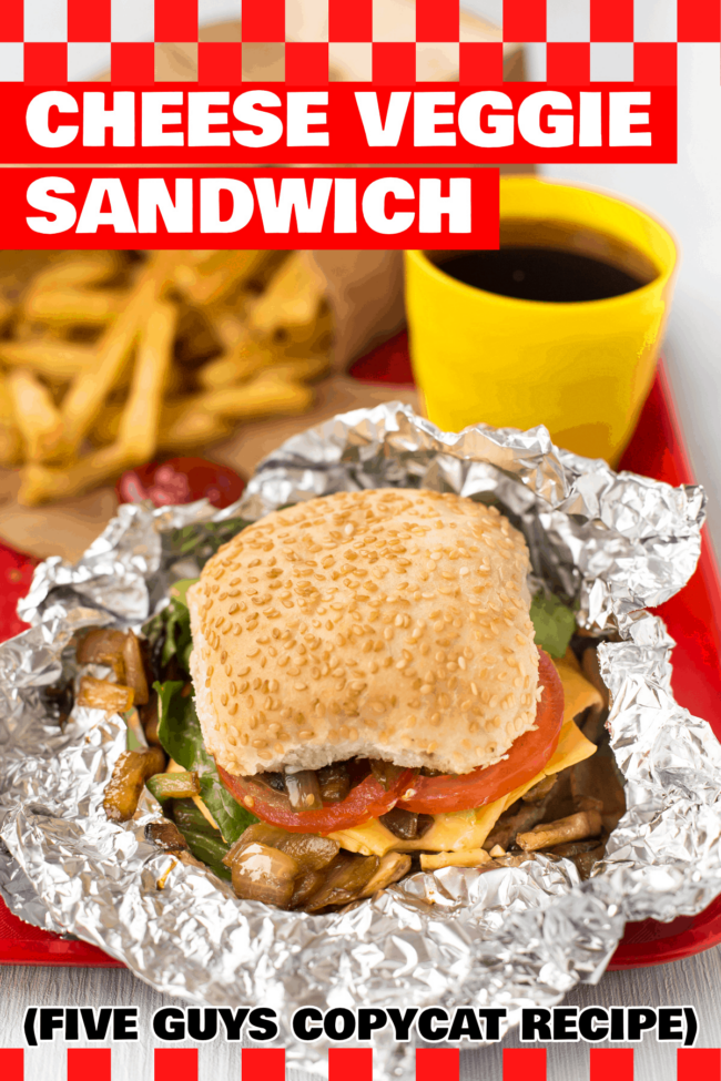 A homemade Five Guys cheese veggie sandwich on a red tray, in partially unwrapped foil.