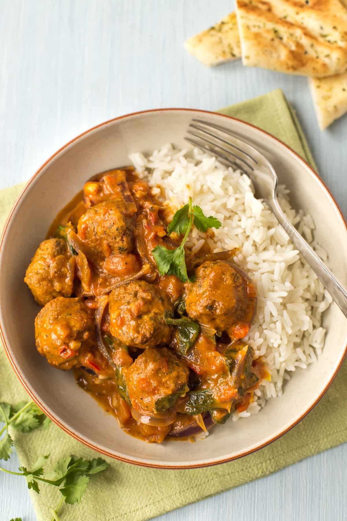 A portion of falafel curry served with rice.