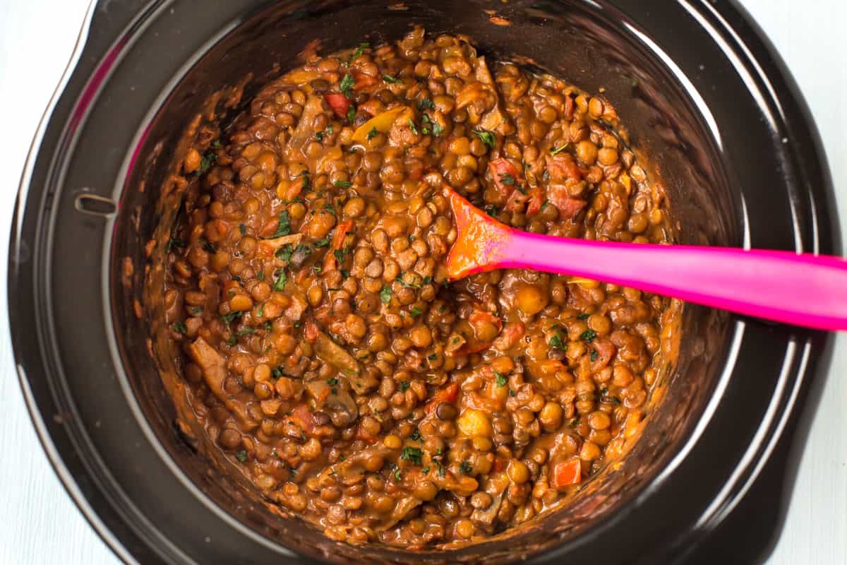 Cheesy lentils in a slow cooker pot.