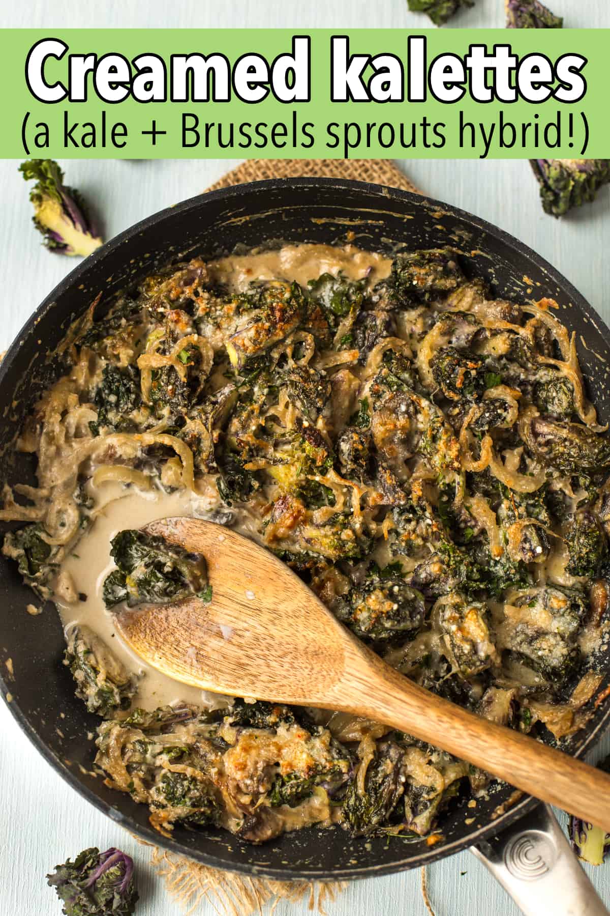 A pan of creamed kalettes with a wooden spoon.