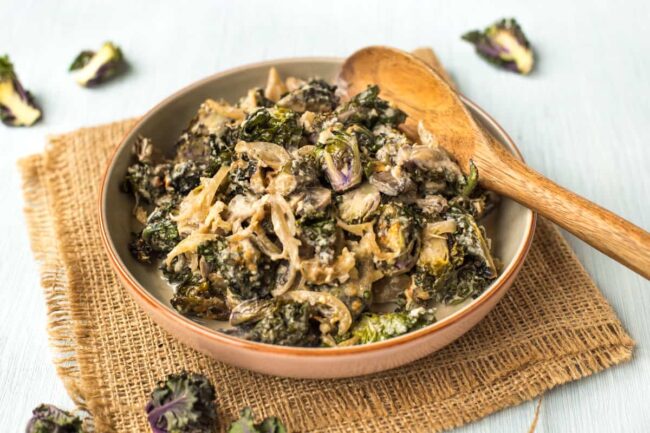 A bowlful of creamed kalettes with caramelised onions.