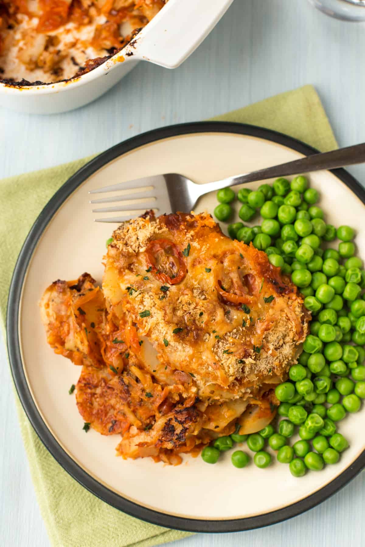 A portion of potato bake with peas.