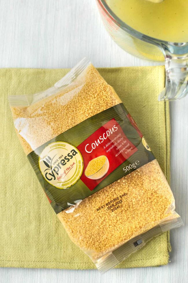 A packet of dried couscous on a green napkin.