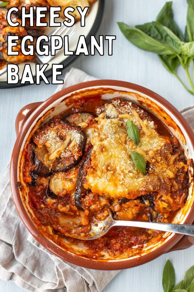 Cheesy eggplant bake in a baking dish, with a large scoop removed.
