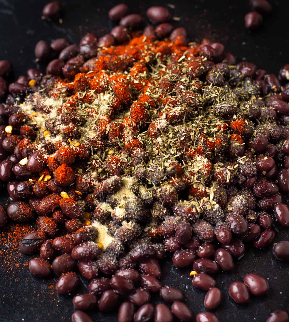 Black beans sprinkled with various dried herbs and spices.