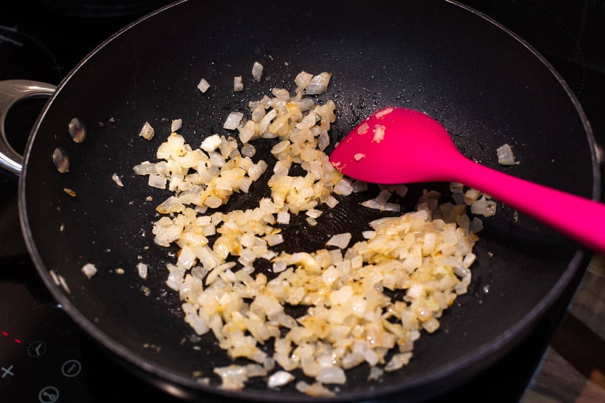 Onion and garlic cooking in a wok.