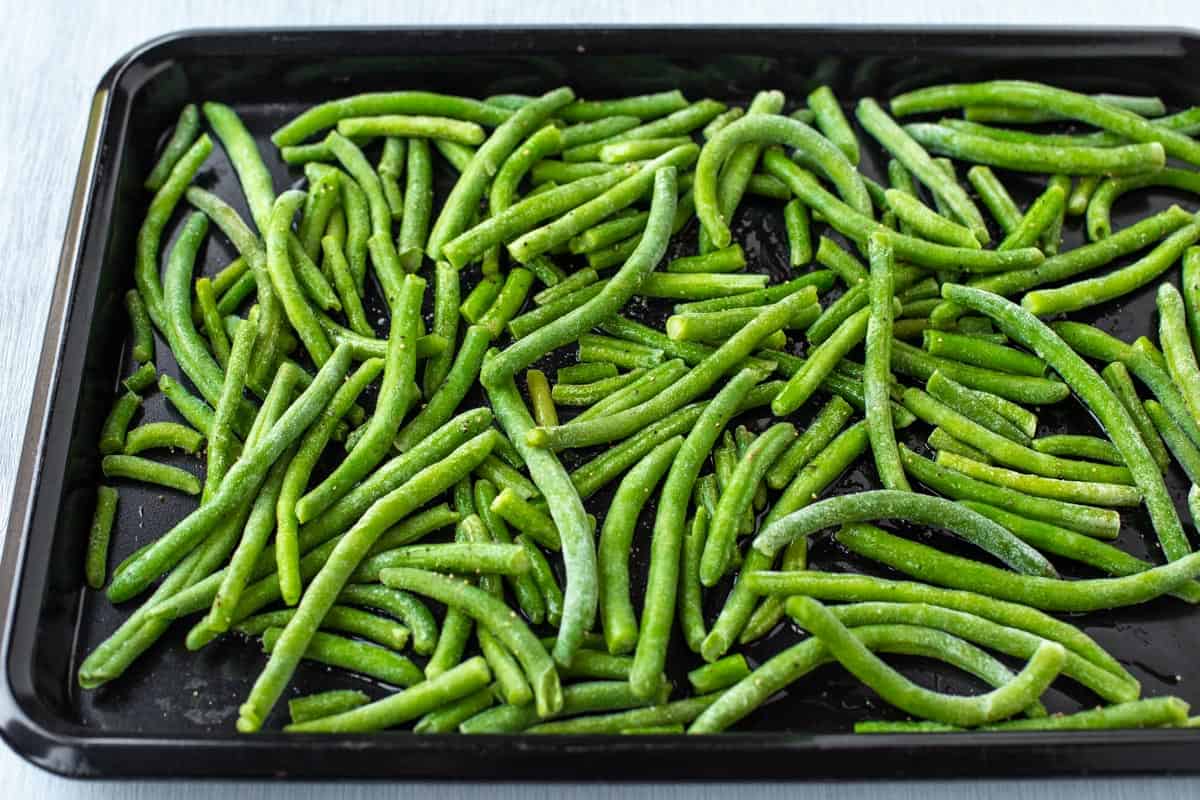 Spread the frozen green beans on a baking tray.