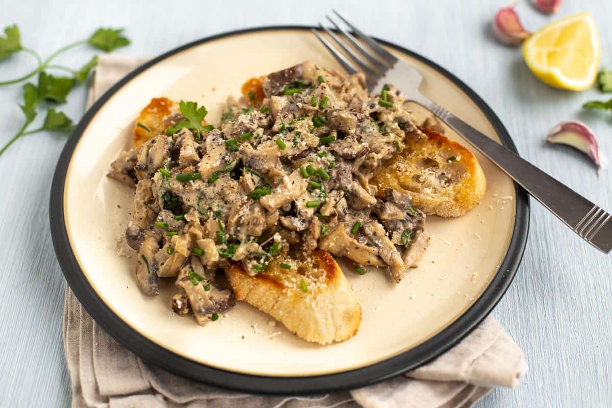 Creamy mushrooms on toast topped with fresh chives.