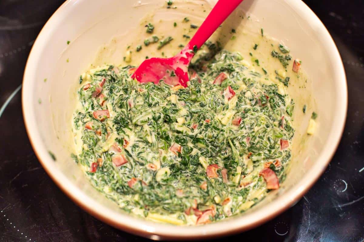 Cold spinach dip in a mixing bowl.