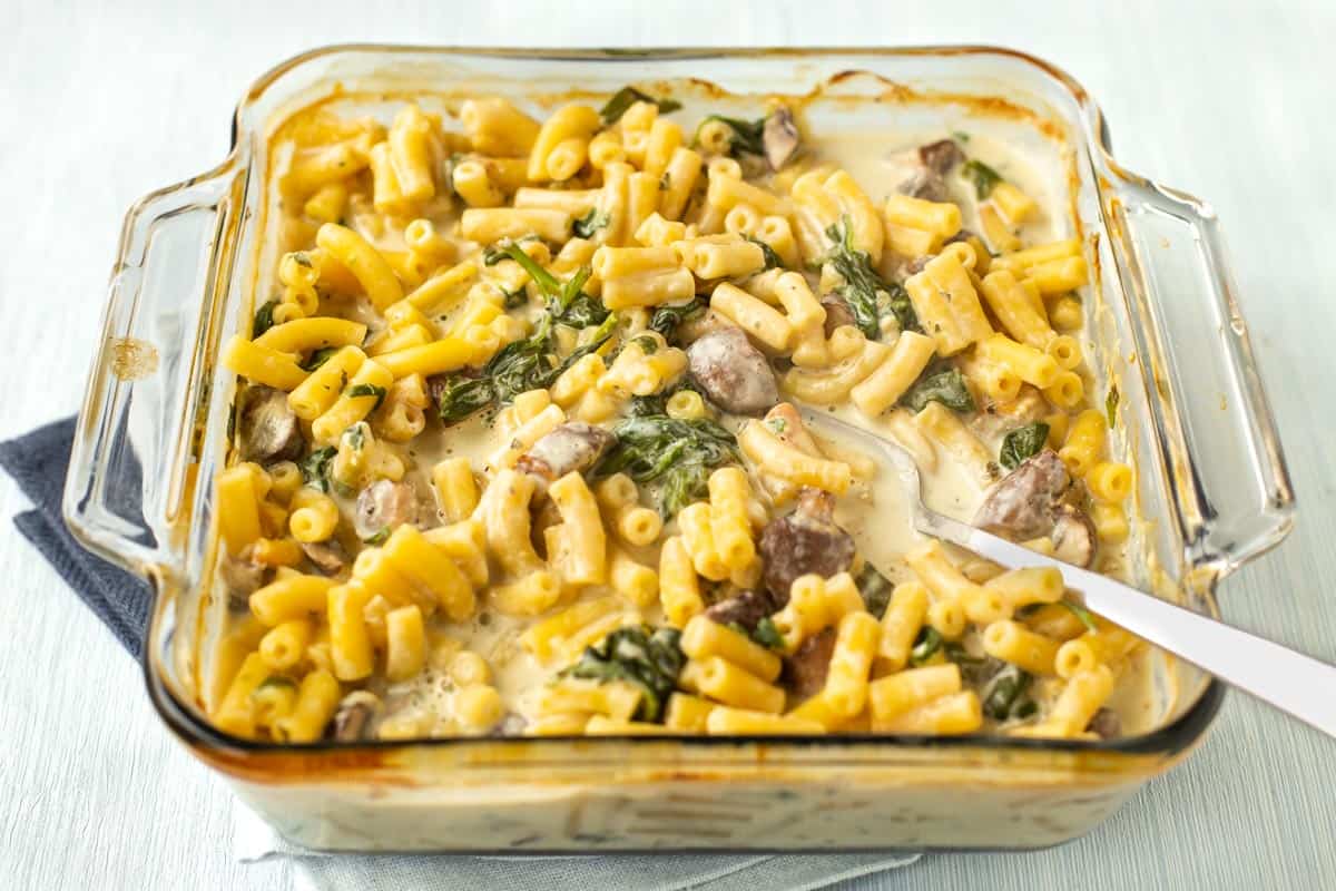 A baking dish of creamy Boursin pasta with mushrooms and spinach.