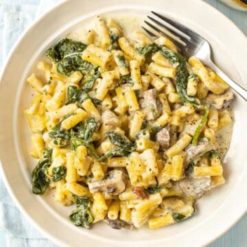 Creamy Boursin pasta with spinach and mushrooms in a bowl.