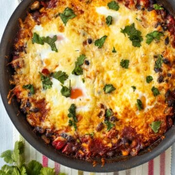 Mexican baked eggs topped with melted cheese.