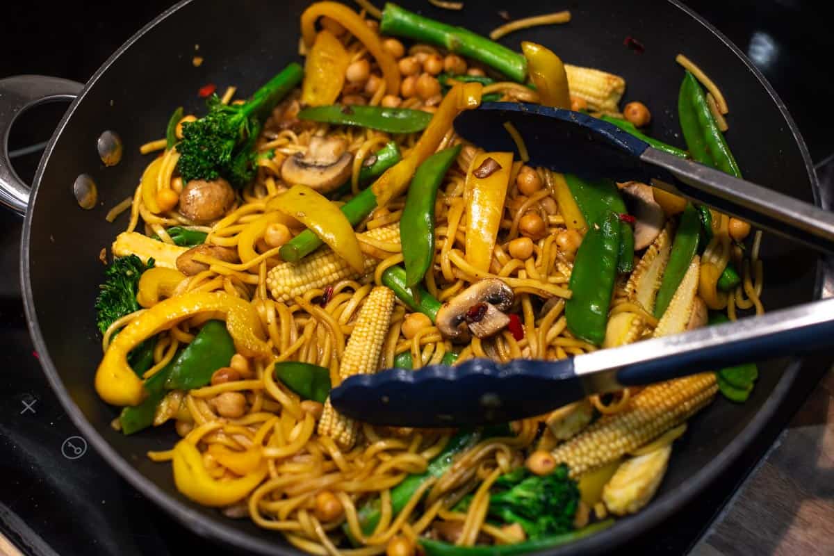 Vegetable and chickpea stir fry in a wok.