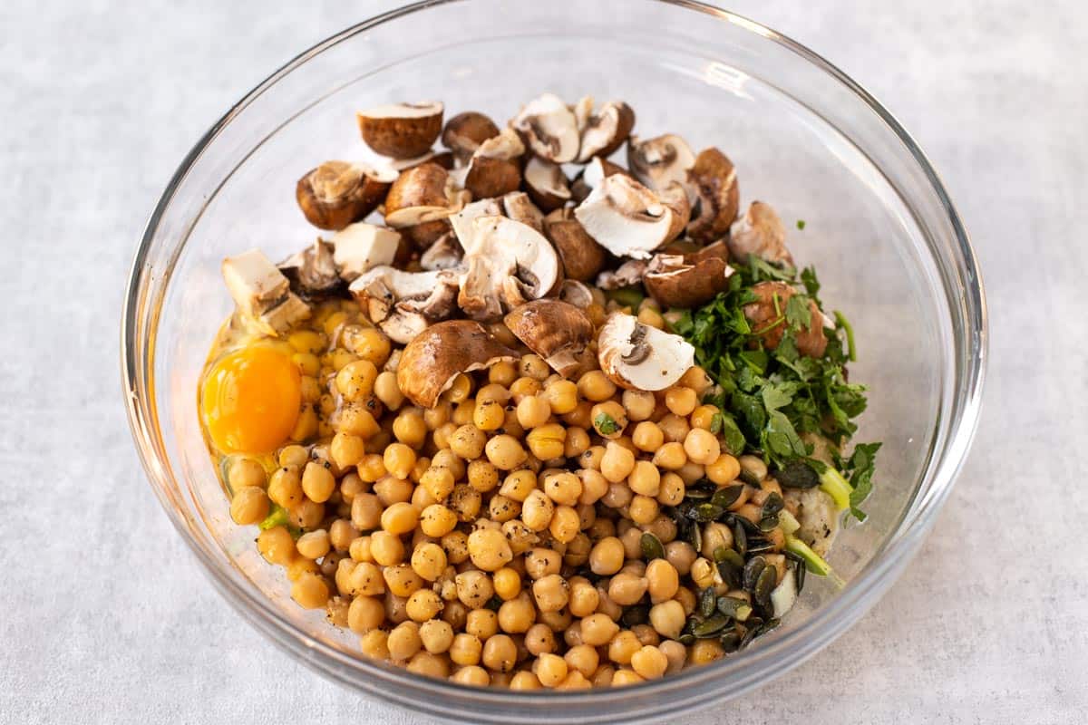 Chickpeas and mushrooms in a mixing bowl.