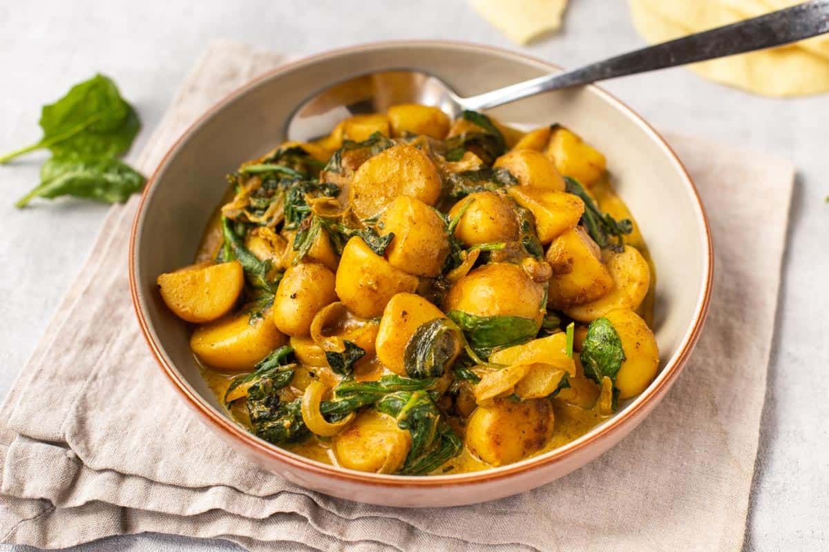 Creamy saag aloo in a bowl.