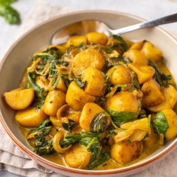 Creamy spinach and potato curry in a bowl.
