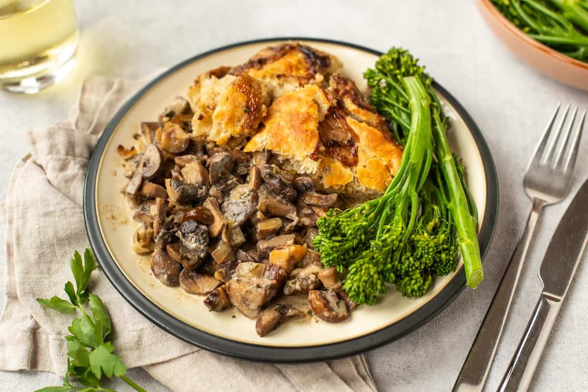 Chestnut and mushroom pie with suet crust on a plate.