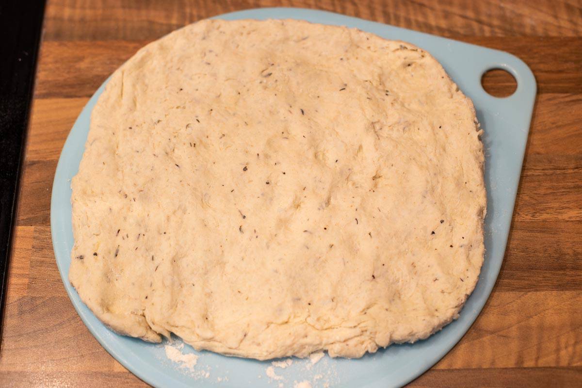 Suet dough pressed out into a rough rectangle on a board.