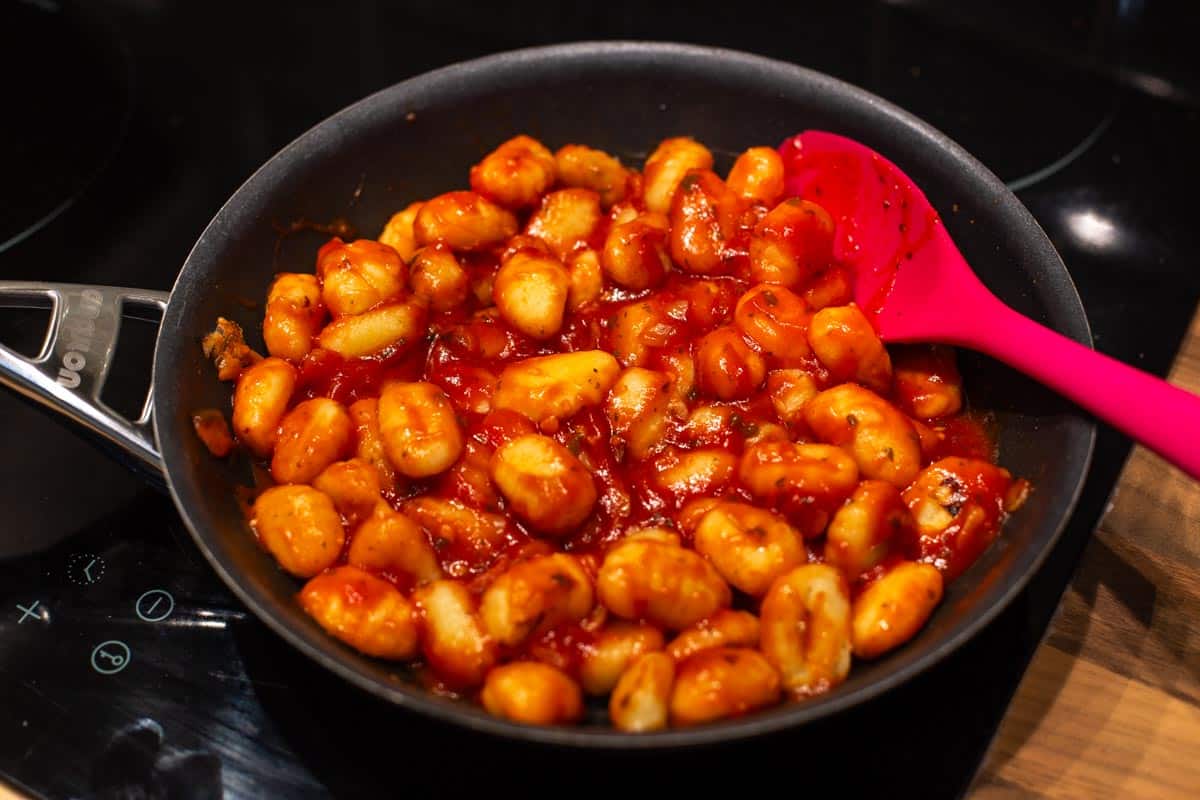 Gnocchi in tomato sauce in a frying pan.