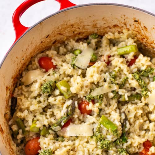 Baked asparagus risotto in a pan with tomatoes and cheese.