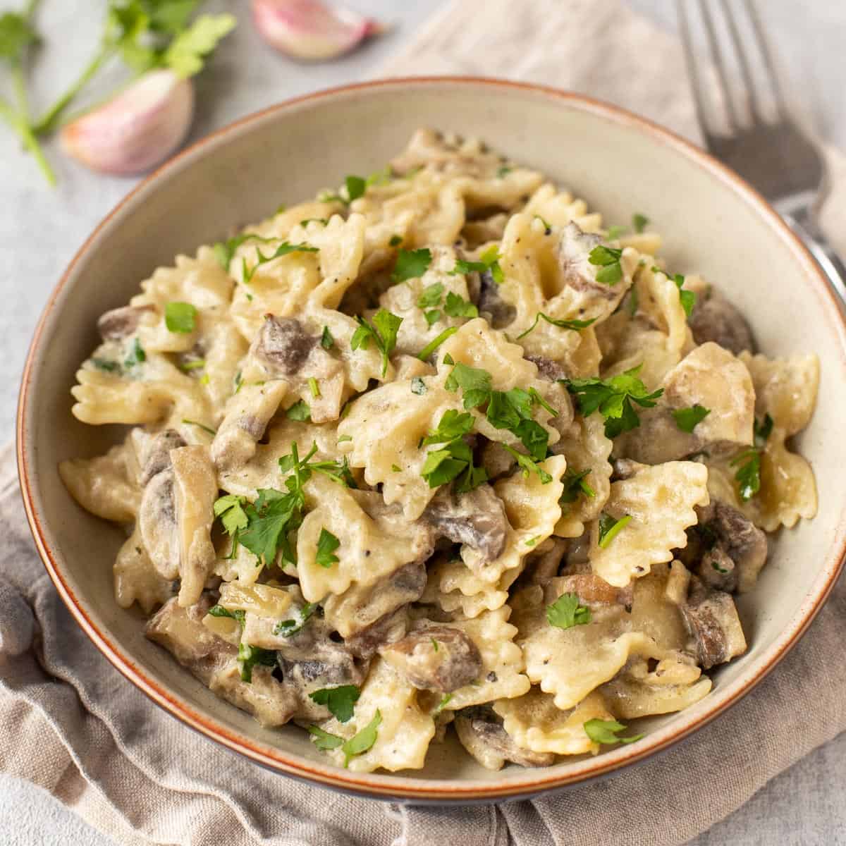 Pasta in a creamy white wine sauce topped with fresh parsley.