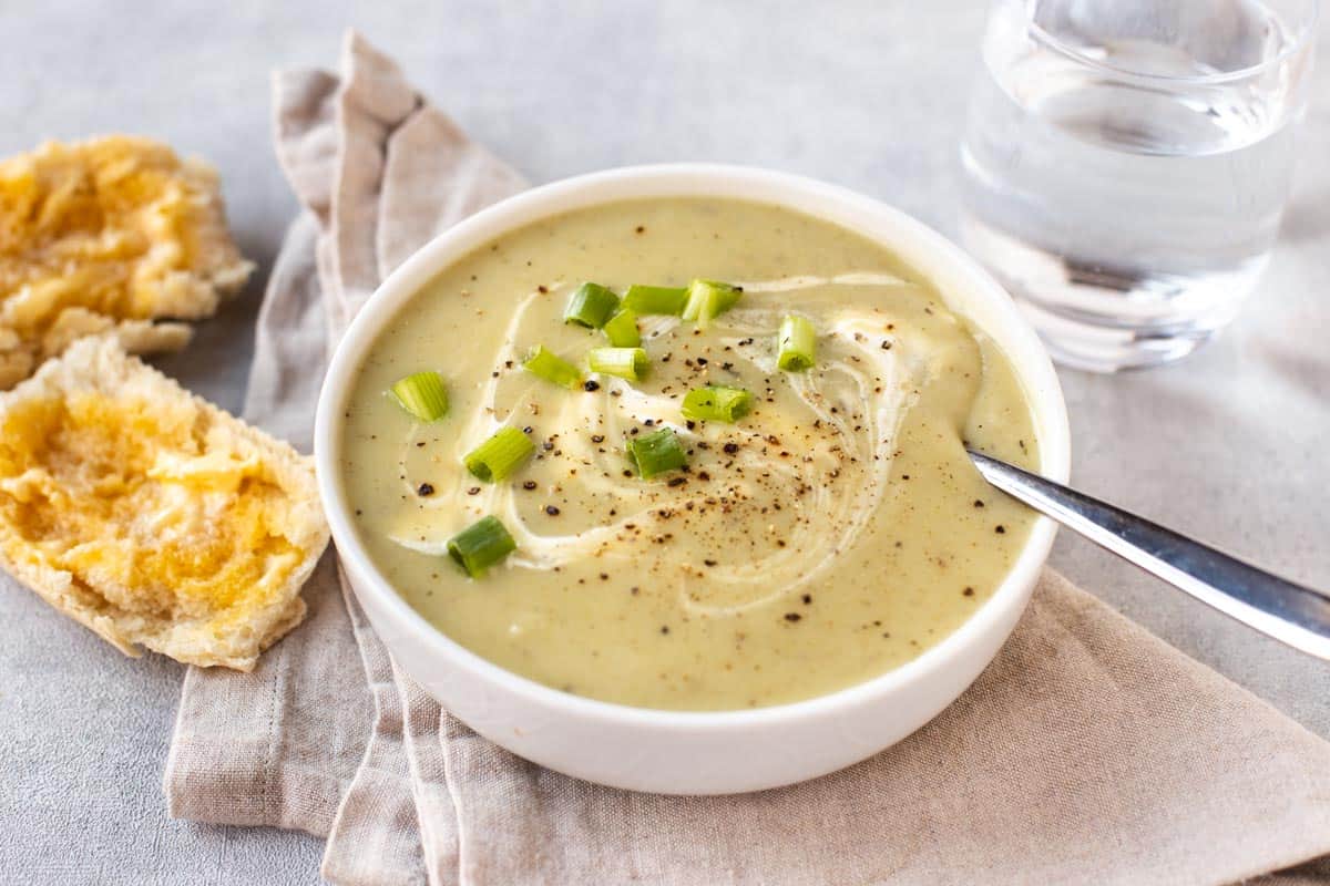 Creamy potato and spring onion soup with chopped onions, cream and black pepper.