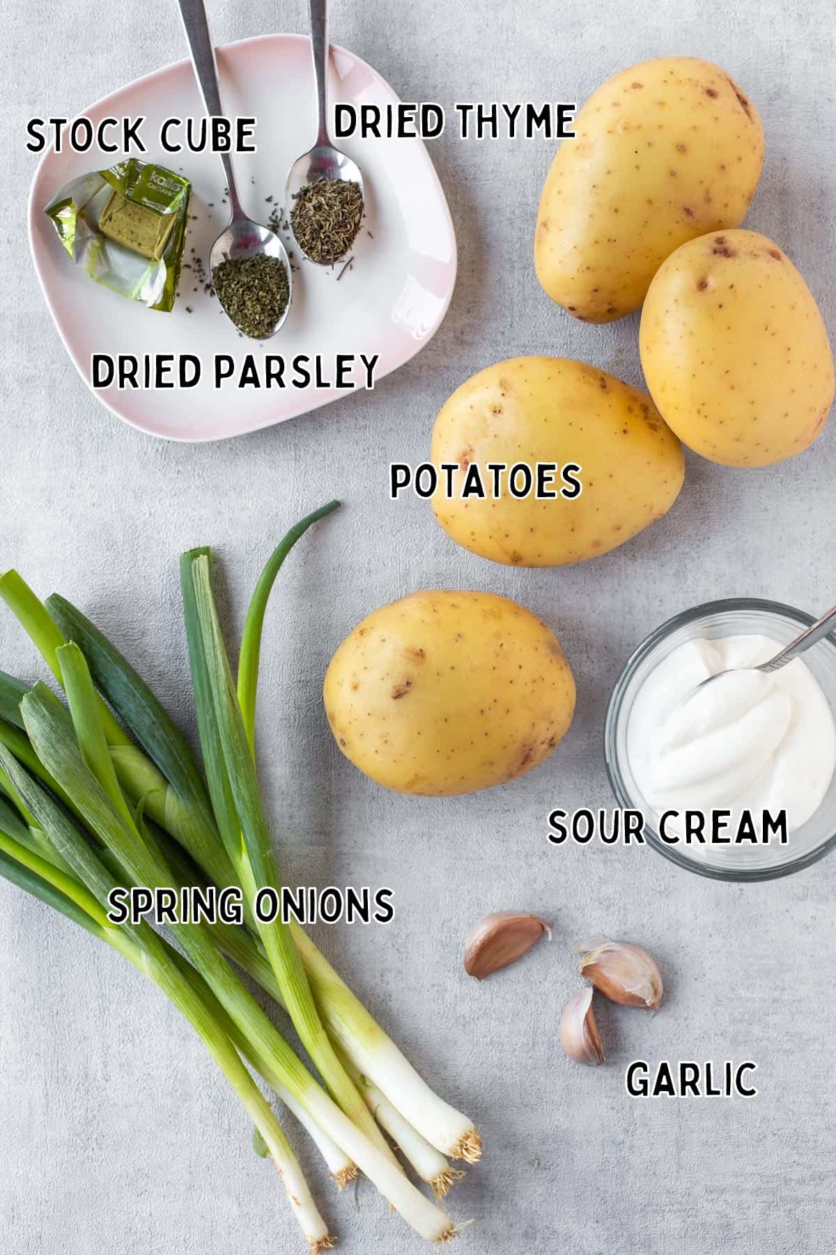 Ingredients for creamy potato and spring onion soup laid out with text overlay.
