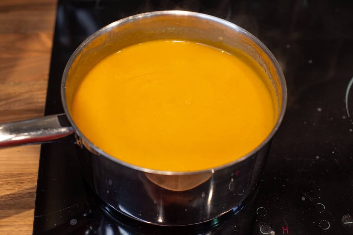 Smooth and creamy red lentil soup in a saucepan.