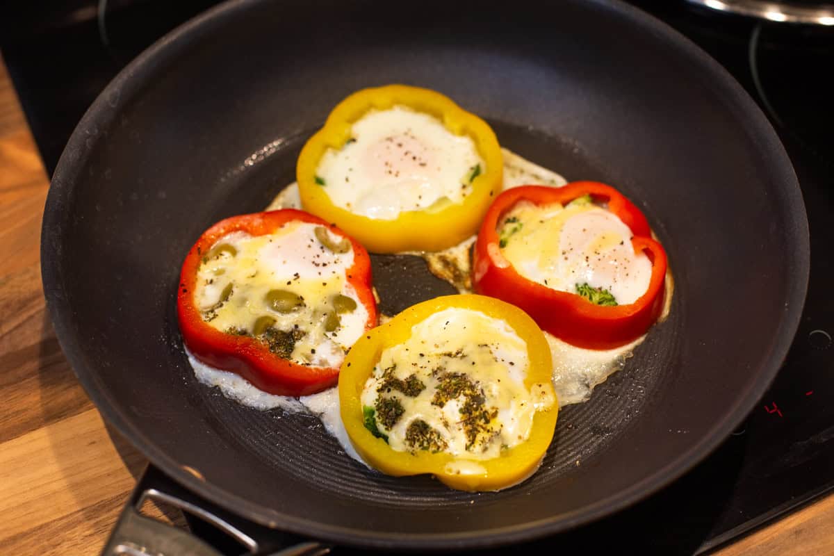 Pepper fried eggs in a frying pan.