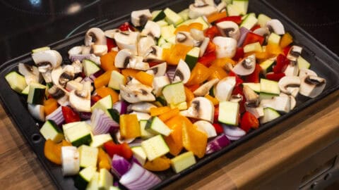 A tray full of colourful chopped vegetables.