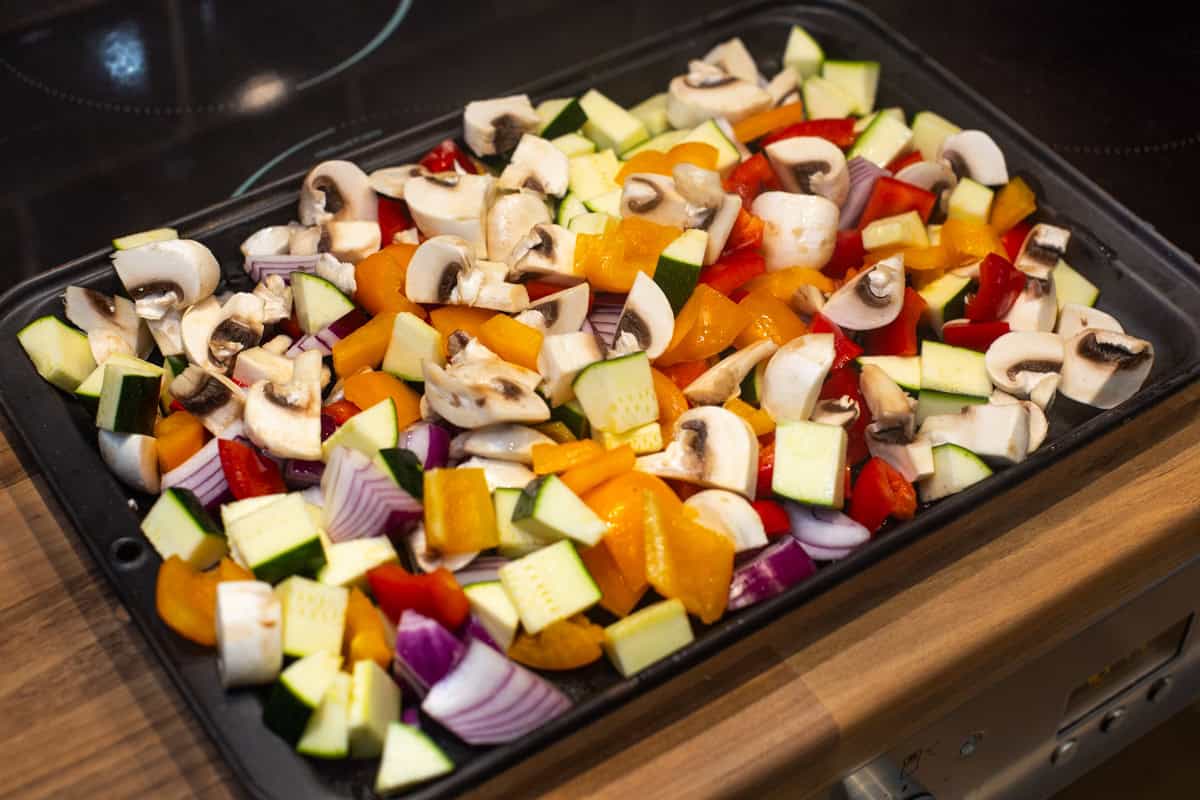A tray full of colourful chopped vegetables.