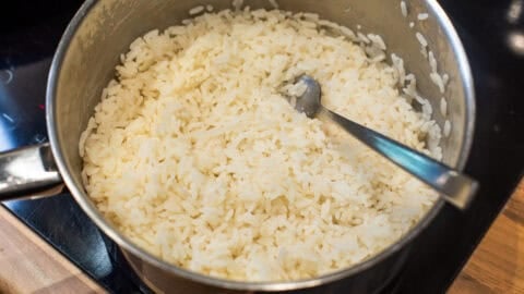 Cooked white rice in a saucepan.