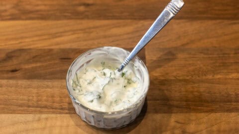 Basil and sour cream mixed in a small bowl.