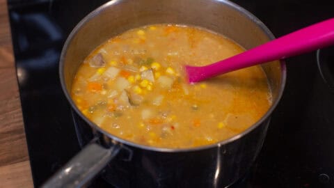 Chunky corn chowder in a saucepan.