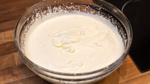 A large bowl of whipped cream and condensed milk.