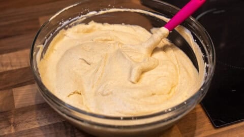 Unfrozen pumpkin pie ice cream mixture in a large bowl.