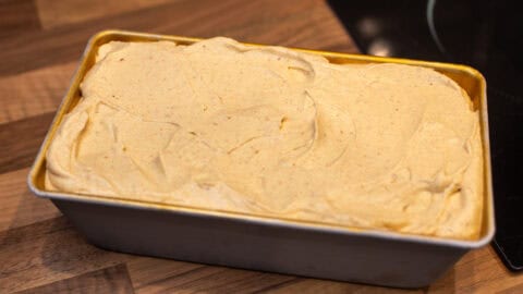 Unfrozen pumpkin ice cream in a loaf tin.