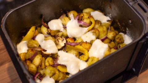 Air fryer gnocchi and vegetables topped with melted mozzarella.