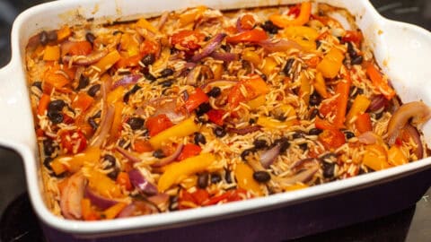 Baked rice with beans and vegetables in a large baking dish.