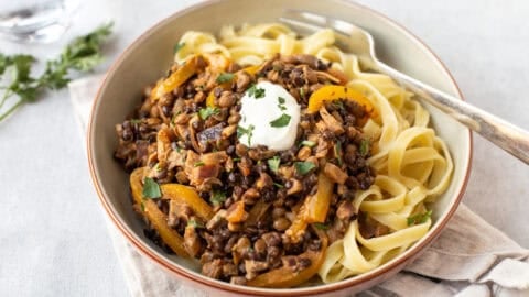 A bowl of tagliatelle topped with easy lentil stroganoff.