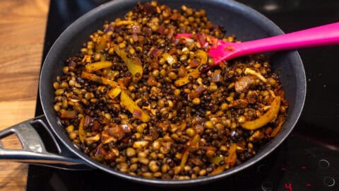 Spiced lentils and vegetables in a pan.