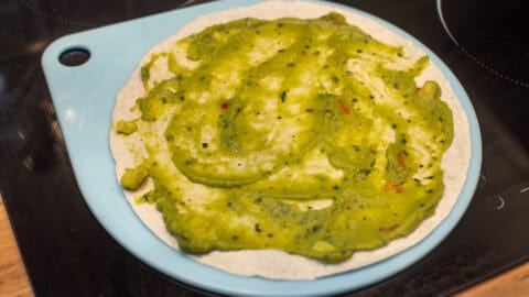 Guacamole spread onto a large flour tortilla.